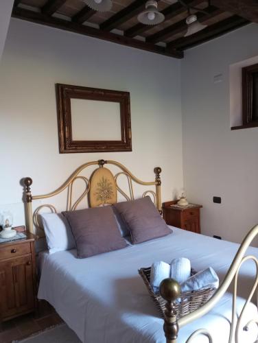 a bedroom with a bed with a basket on it at OLEA casa vacanze in Todi