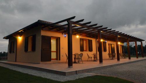 a small house with a pergola on top of it at Agriturismo la Ghiandaia Alghero in Santa Maria la Palma