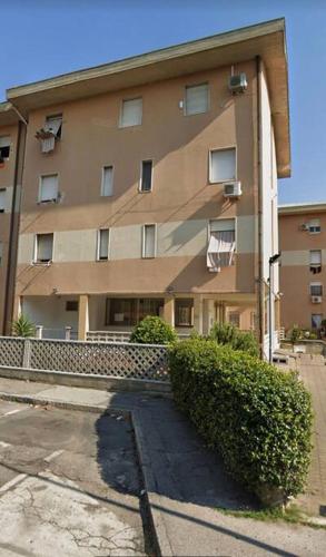 a large apartment building with a hedge in front of it at Marble apartment in Prato