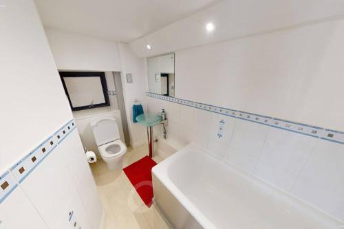 a white bathroom with a toilet and a sink at Central Nottingham sleeps up to 4 in Nottingham