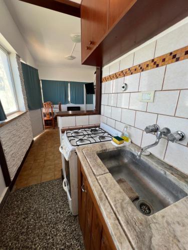 a kitchen with a sink and a stove at La PerlaApart in Mar del Plata