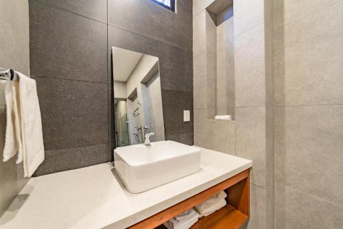 a bathroom with a white sink and a mirror at 3027 - Santa Cruz Condo in Santa Cruz Huatulco