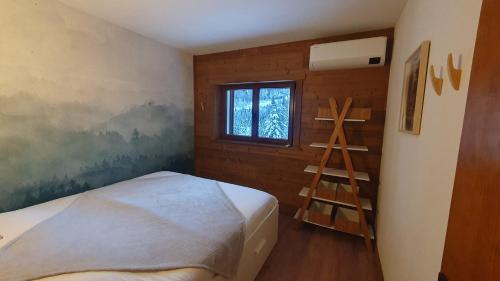 a bedroom with a ladder next to a bed at Chalet Le Dahu in La Bresse