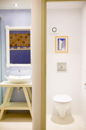 a bathroom with a sink and a toilet at Montana Villa in Stelida