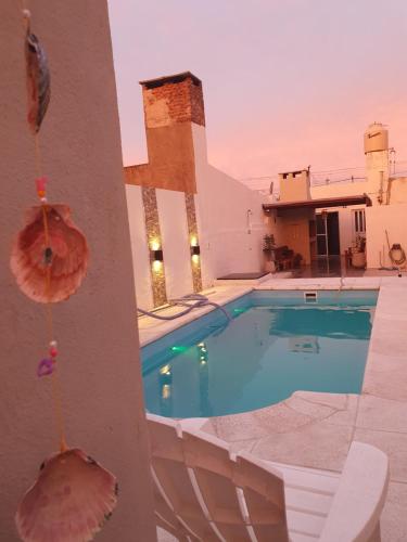 a swimming pool on the roof of a house at Quincho Los Abuelos in Chivilcoy