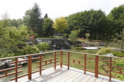 a deck with a view of a garden at Koru Hôtel & Private Wellness in Autre-Église