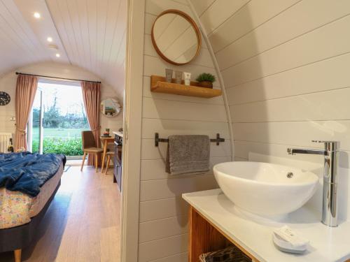 a bathroom with a sink and a bed in a room at No Deer in Ashbourne
