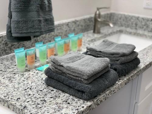 a bathroom counter with towels and a sink at King Suite- Walk to UNC/Franklin St, Near Hospital in Chapel Hill