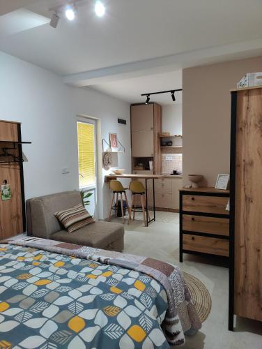 a bedroom with a bed and a couch and a kitchen at Miro guesthouse in Tivat