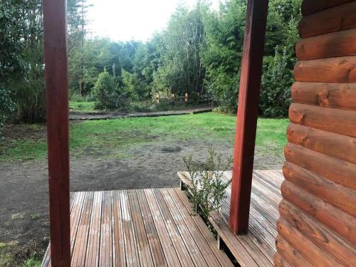 uitzicht op een tuin vanaf de veranda van een hut bij Cabaña Haywood in Puerto Varas