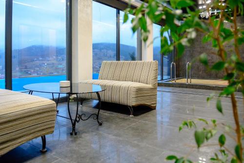 a living room with a chair and a table at Севеней Готель in Bukovel