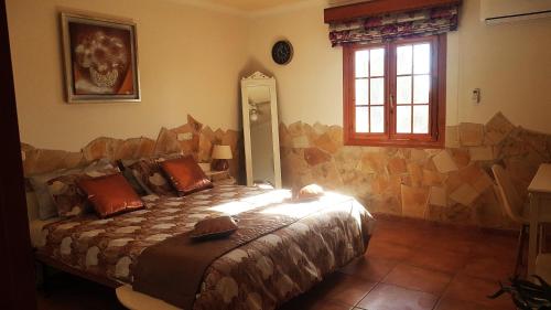 a bedroom with a bed in a room with a window at Charming Villa La Mar in Albox