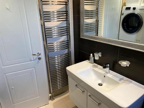 a bathroom with a sink and a mirror at Luxury 4BR with 3 Bathrooms Apartment in Marousi in Athens