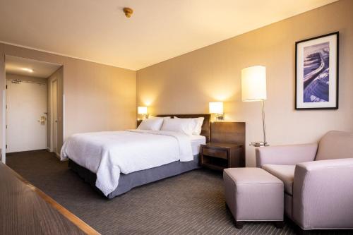 a hotel room with a bed and a couch at Holiday Inn Express - Iquique by IHG in Iquique