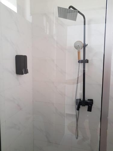 a shower with a shower head in a bathroom at TIANDE Boutique Hotel in Pwani Mchangani