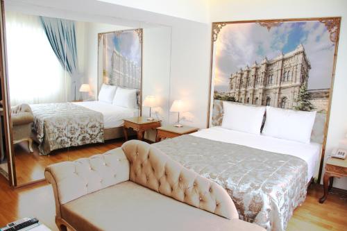 a hotel room with two beds and a couch at Elite Marmara Bosphorus&Suites in Istanbul