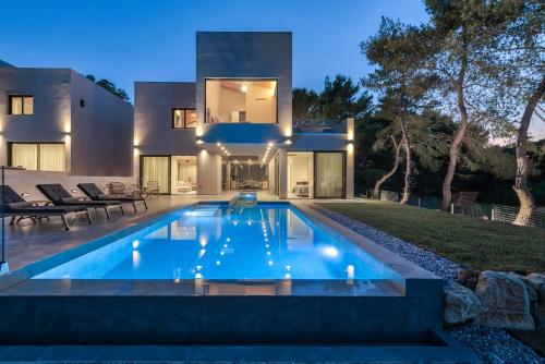 a swimming pool in the backyard of a house at Luxury Villa Mon I Vassilikos in Vasilikos