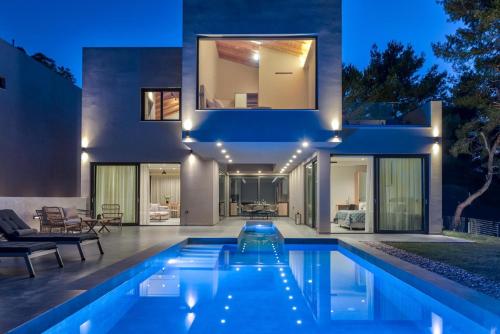 a house with a swimming pool at night at Luxury Villa Mon I Vassilikos in Vasilikos