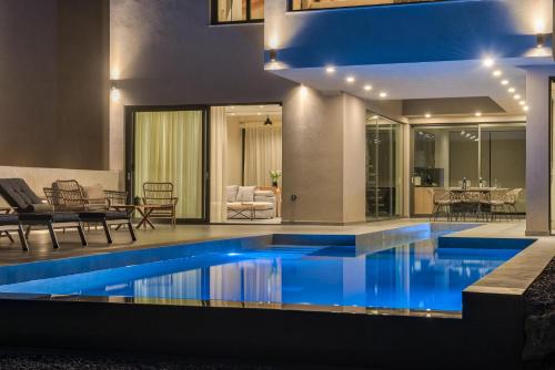 a swimming pool in the middle of a house at Luxury Villa Mon I Vassilikos in Vasilikos