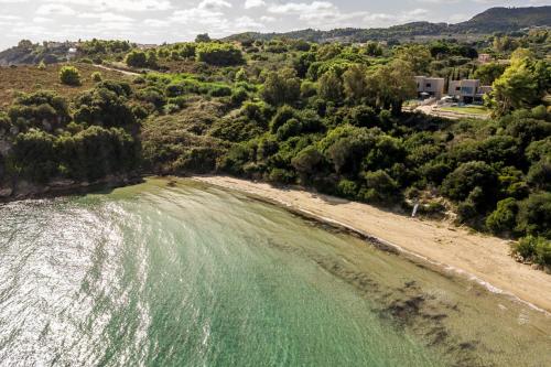 an aerial view of a beach with green water at Luxury Villa Mon II Vassilikos in Vasilikos