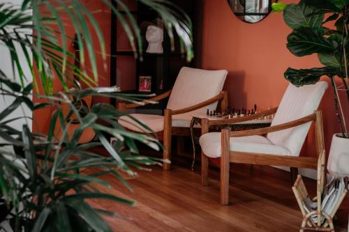 a room with two chairs and a chess board on a table at Fancy Fritz B&B in Swakopmund