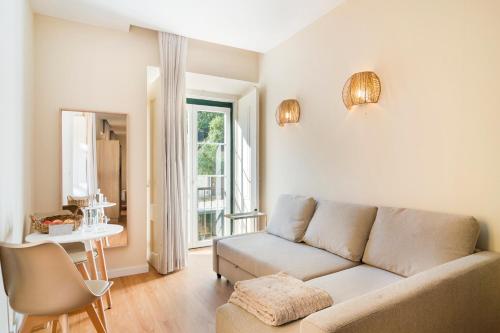 a living room with a couch and a table at Metropolitan Living Lisbon - Laranjeiras in Lisbon