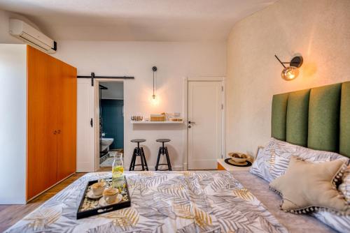a bedroom with a large bed with a green headboard at Miro guesthouse in Tivat
