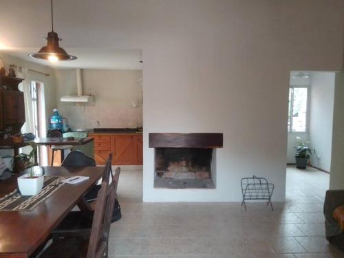 a living room with a fireplace in the wall at Casa c/pileta Cosquin in Cosquín