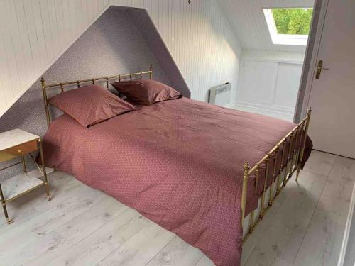 ein Schlafzimmer mit einem großen Bett mit lila Bettwäsche und Kissen in der Unterkunft Maison de charme avec vue sur château in Pierrefonds