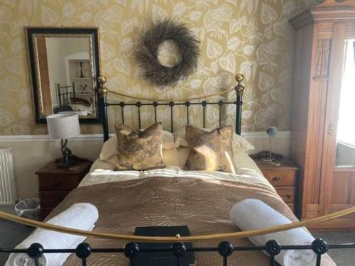 a bedroom with a bed with a large mirror at Heathfield Bed and Breakfast in Whitby