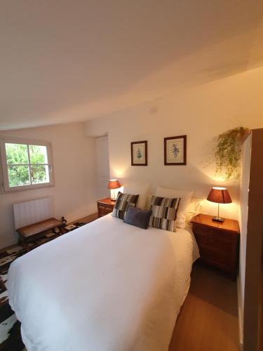 a bedroom with a large white bed and two lamps at Lou Pantai, Bed and breakfast, Double Bedroom in Aix-en-Provence