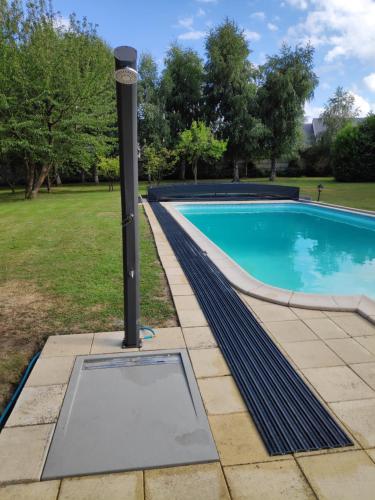 a light pole next to a swimming pool at Demeure du Haut Canteloup in Honfleur