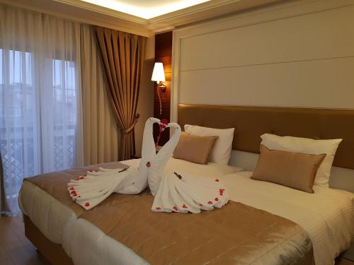 a hotel room with a bed with two people dressed in white at OTEL MARCELLO in Istanbul
