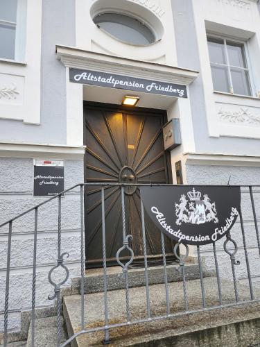 a front door of a building with a gate at Altstadtpension Friedberg in Friedberg