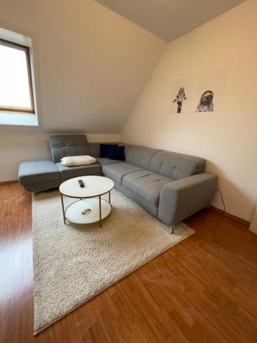 ein Wohnzimmer mit einem Sofa und einem Tisch in der Unterkunft JonnysSleepOver in Osnabrück