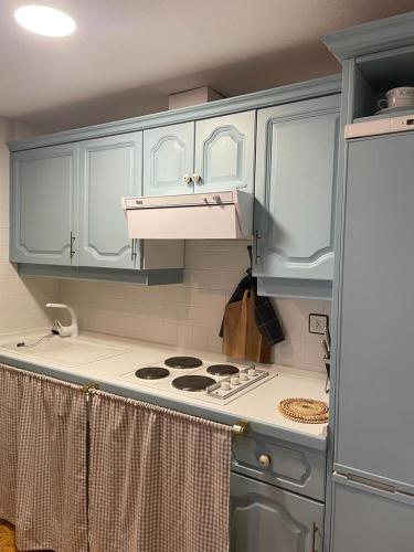 a kitchen with white cabinets and a stove top oven at Pacino Jaca in Jaca