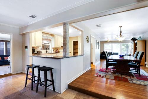 a kitchen and dining room with a table and chairs at Fortuitous - A Birdy Vacation Rental in San Antonio