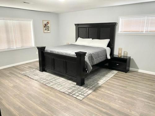 a bedroom with a bed with a black bed frame at Karizma Haven in Midtown Memphis in Memphis
