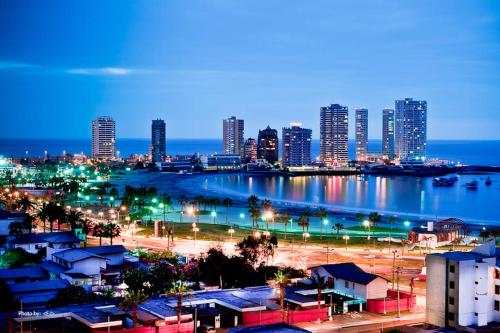 a view of a city at night with a harbor at Nautilus Peninsula Piso 14 (Cerca de Todo) in Iquique
