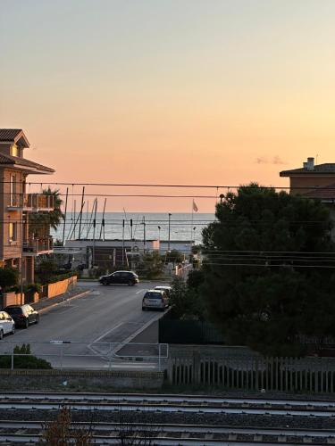 a street with cars parked on a road near the ocean at URBAN PRIVATE SPA in Porto SantʼElpidio