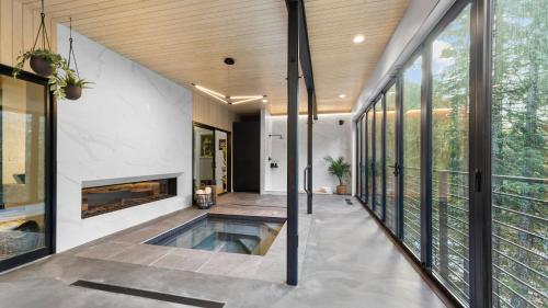 a house with a swimming pool and a fireplace at RAVN HAÜS - Oregon's Premier Alpine Retreat in Government Camp