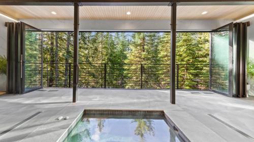 an indoor pool in a house with a large window at Ravn Haus in Government Camp