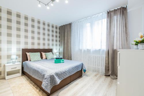a bedroom with a bed and a large window at VIP Apartments - Apartamenty na Szewskiej in Wrocław