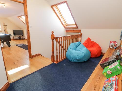a room with a staircase and a bean bag chair at Y Tylwyth in Blaenau-Ffestiniog