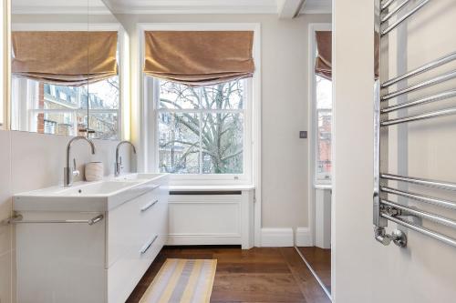 a bathroom with a sink and a window at Luxurious Apartment in Kensington in London