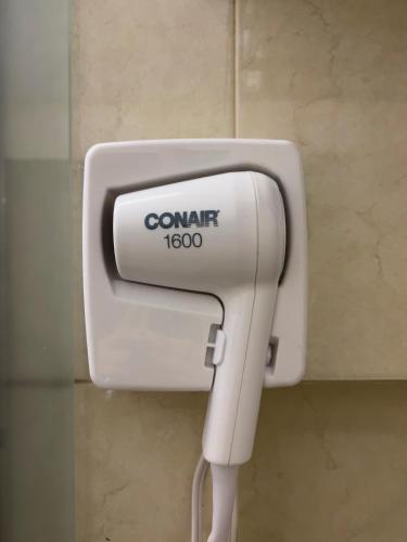 a soap dispenser on a wall in a bathroom at Hotel Principal in Mexico City