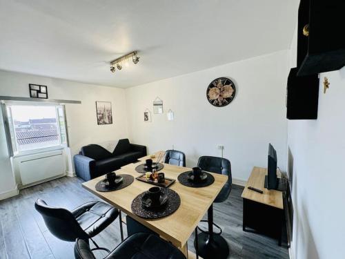 a living room with a table and chairs and a couch at ISVAL Wifi-Hyper Centre Cognac in Cognac