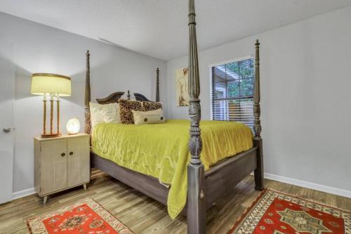 a bedroom with a bed and a lamp and a window at Ain't Nothin' Fancy in River Oaks