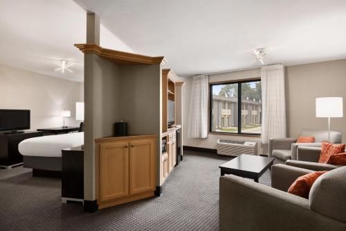 a hotel room with a bed and a living room at Carrollton Hotel in Carroll
