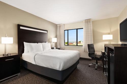 a hotel room with a bed and a television at Carrollton Hotel in Carroll